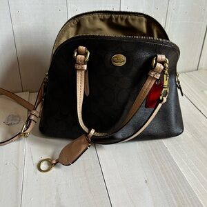 Coach Peyton black and tan domed satchel Bag with cross body strap.